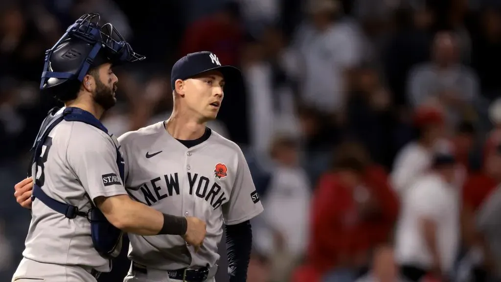 Austin Wells #28 and Luke Weaver #30 of the New York Yankees celebrate after the 5-1 win against the Los Angeles Angels