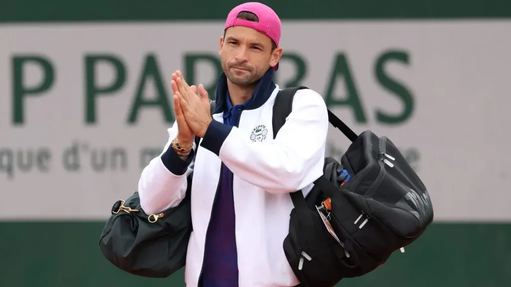 Grigor Dimitrov applauds spectators after retiring injured from his Men’s Singles First Round match against Ethan Quinn of United States during Day Three of the 2025 French Open. (Source: Julian Finney/Getty Images)