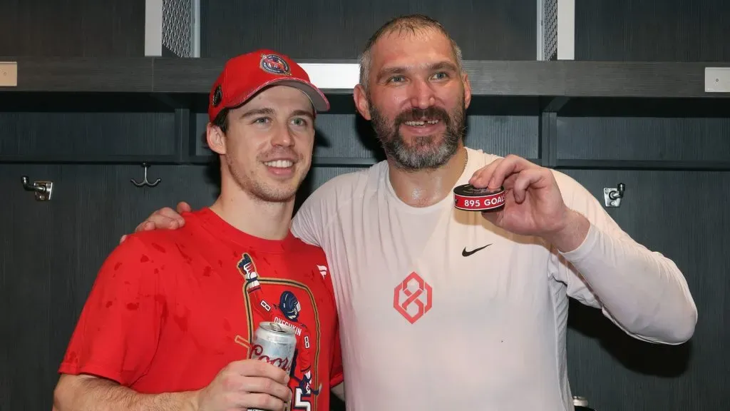 Anthony Beauvillier #72 (l) poses with Alex Ovechkin #8 of the Washington Capitals (r) following Ovechkin’s record-breaking goal against the New York Islanders at UBS Arena on April 06, 2025 in Elmont, New York. (Photo by Bruce Bennett/Getty Images)