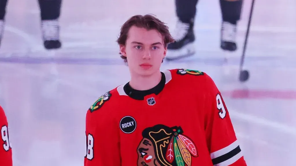 Connor Bedard #98 of the Chicago Blackhawks observes the playing of the national anthem prior to the game against the Vegas Golden Knights at the United Center on October 21, 2023 in Chicago, Illinois.