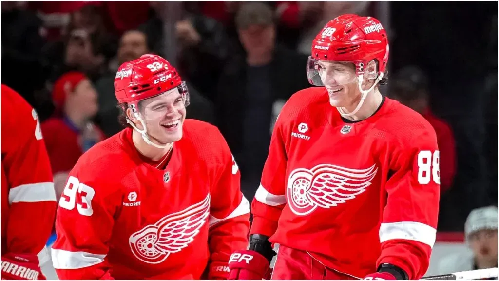 Alex DeBrincat #93 and Patrick Kane #88 of the Detroit Red Wings celebrate Kane’s goal against the New York Islanders during the third period at Little Caesars Arena on March 21, 2024 in Detroit, Michigan.