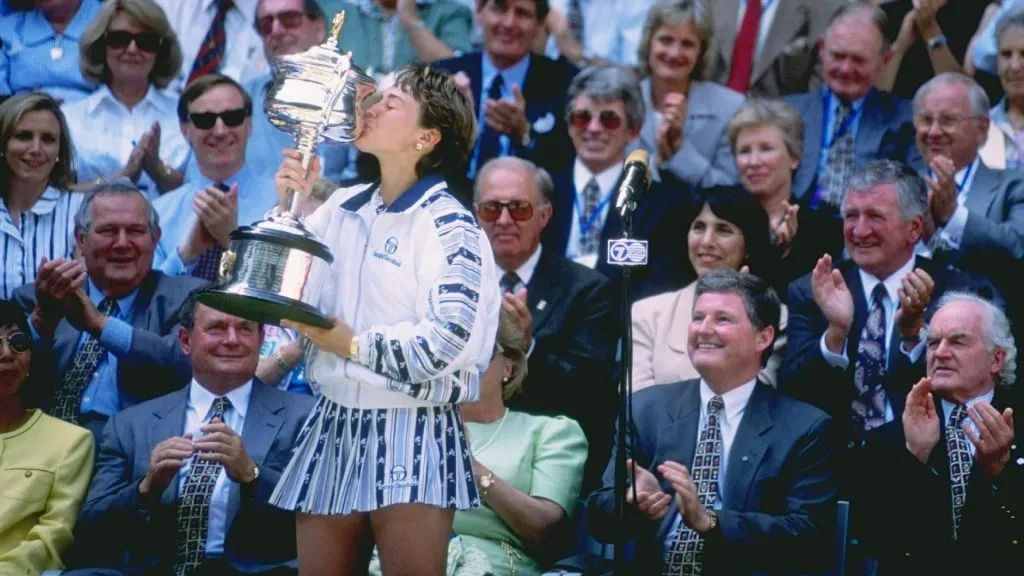 Martina Hingis celebrates by kissing the trophy after winning her first grand slam title, by defeating Mary Pierce during the Australian Open. (Clive Brunskill/Allsport/Getty Images)