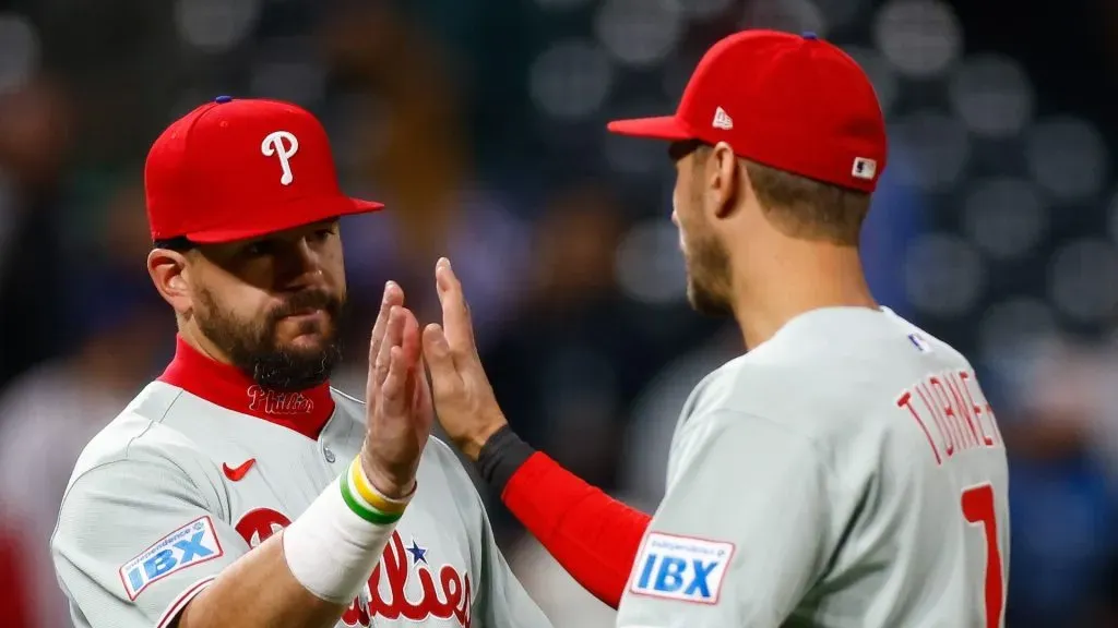 Kyle Schwarber #12 and Trea Turner #7 of the Philadelphia Phillies celebrate after their 9-3 win against the Colorado Rockies