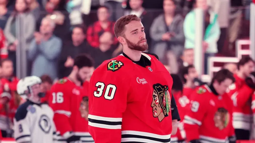 Spencer Knight #30 of the Chicago Blackhawks looks on during the playing of the national anthem prior to the game against the Seattle Kraken at the United Center on March 18, 2025 in Chicago, Illinois.