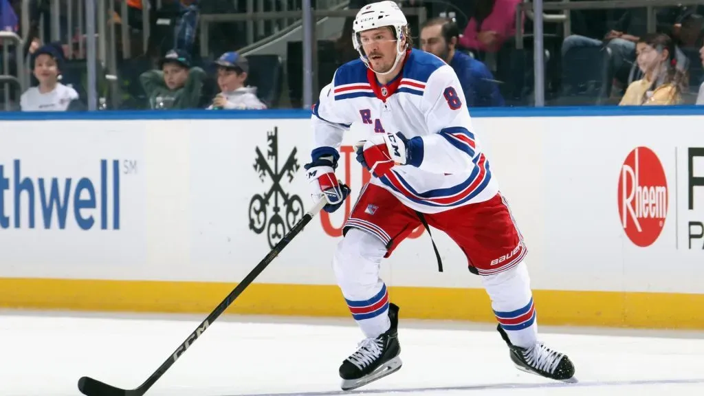 J.T. Miller during a midseason game for the New York Rangers, showcasing his aggressive playing style.