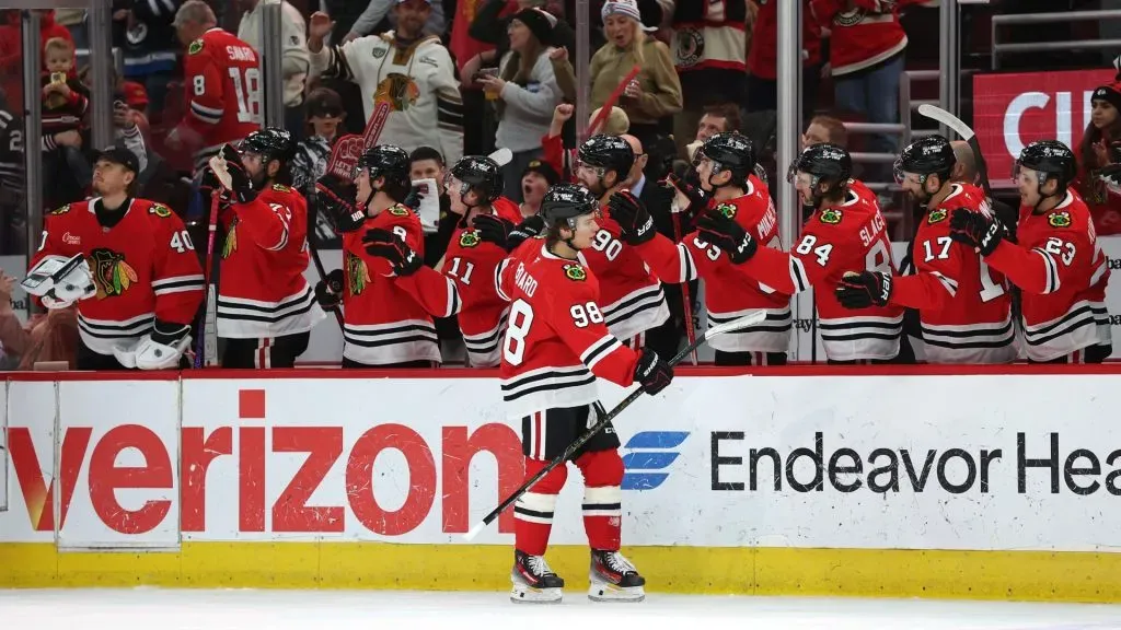 Connor Bedard #98 of the Chicago Blackhawks is congratulated by teammates. (Photo by Stacy Revere/Getty Images)