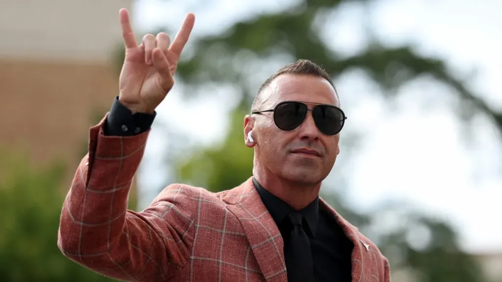 Steve Sarkisian makes the 'Horns Up' hand-signal
