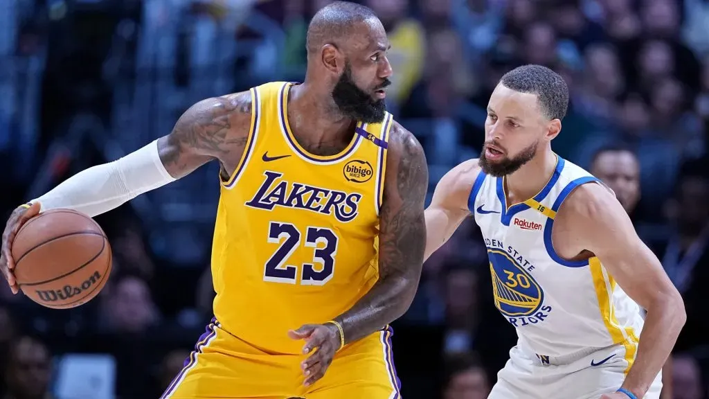 Lakers veteran LeBron James holding the ball against Stephen Curry