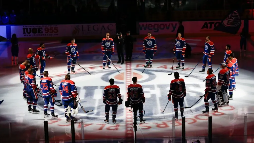 The Oilers stand at centre ice during pre-game introductions against the Flames. Codie McLachlan/Getty Images