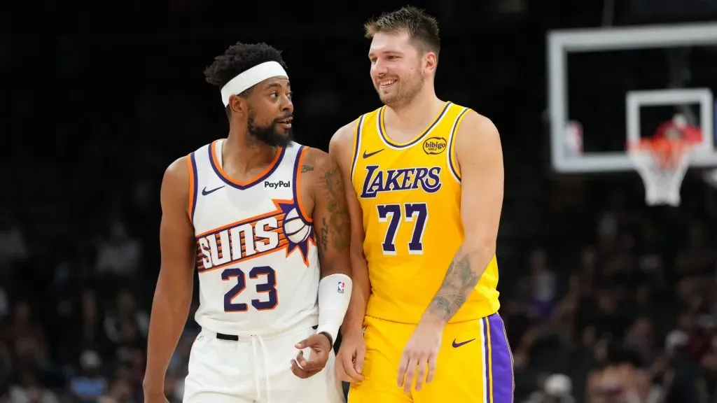 Luka Doncic talks with Jordan Goodwin during the NBA preseason game. (Getty Images)