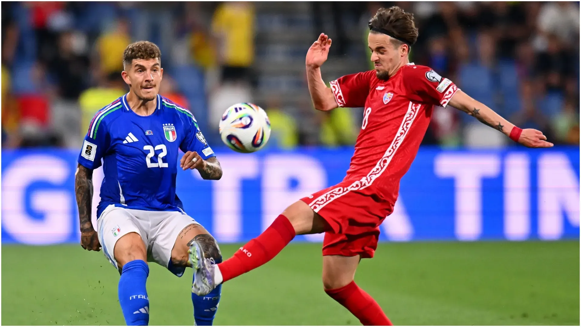 Giovanni Di Lorenzo of Italy competes for the ball with Stefan Bodisteanu of Moldova – Alessandro Sabattini/Getty Images