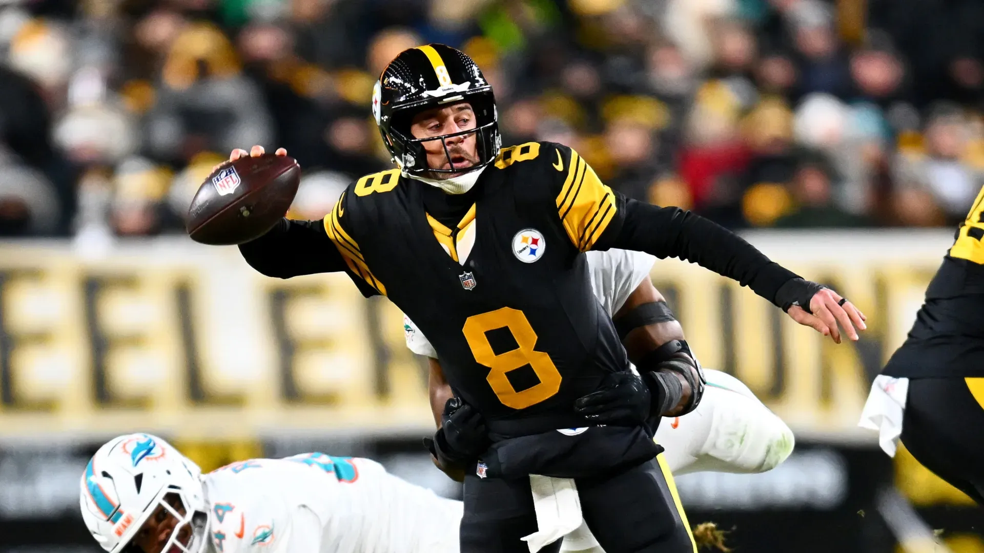 Aaron Rodgers being sacked by Jordyn Brooks