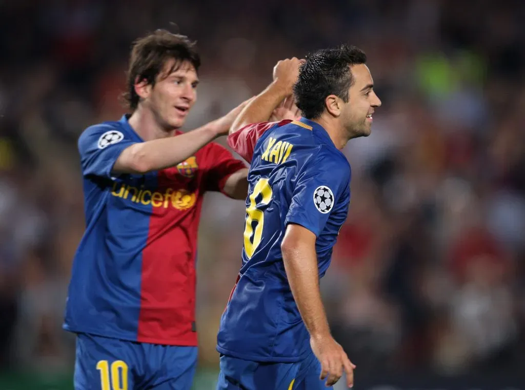 BARCELONA, SPAIN – SEPTEMBER 16:  Xavi Hernandez (R) of Barcelona celebrates his goal with teammate Lionel Messi during the UEFA Champions League Group C match between Barcelona and Sporting Lisbon at the Camp Nou stadium on September 16, 2008 in Barcelona, Spain. (Photo by Jasper Juinen/Getty Images)