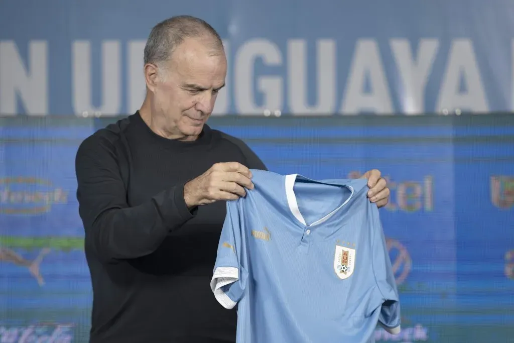 MONTEVIDEO, URUGUAY – MAY 17:  Marcelo Bielsa holds an Uruguay jersey during his presentation as coach of Uruguayan at Centenario Stadium on May 17, 2023 in Montevideo, Uruguay. (Photo by Sandro Pereyra/Getty Images)