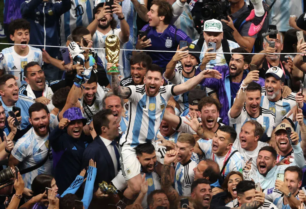 LUSAIL CITY, QATAR – DECEMBER 18: Lionel Messi of Argentina celebrates with the world cup trophy following his sides victory  during the FIFA World Cup Qatar 2022 Final match between Argentina and France at Lusail Stadium on December 18, 2022 in Lusail City, Qatar. (Photo by Alex Pantling/Getty Images)
