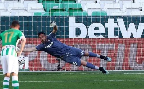 SEVILLE, SPAIN - APRIL 18: Claudio Bravo of Real Betis fails to save as Carlos Soler of Valencia CF scores their team's second goal from the penalty spot during the La Liga Santander match between Real Betis and Valencia CF at Estadio Benito Villamarin on April 18, 2021 in Seville, Spain. Sporting stadiums around Spain remain under strict restrictions due to the Coronavirus Pandemic as Government social distancing laws prohibit fans inside venues resulting in games being played behind closed doors. (Photo by Fran Santiago/Getty Images)-Not Released (NR)