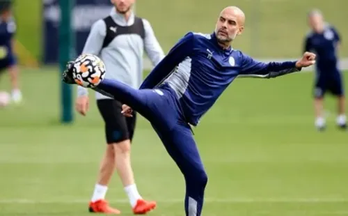 MANCHESTER, ENGLAND - AUGUST 12: Pep Guardiola, manager of Manchester City controls the ball during a training session at Manchester City Football Academy on August 12, 2021 in Manchester, England. (Photo by Matt McNulty - Manchester City/Manchester City FC via Getty Images)