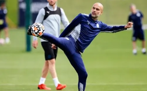 MANCHESTER, ENGLAND - AUGUST 12: Pep Guardiola, manager of Manchester City controls the ball during a training session at Manchester City Football Academy on August 12, 2021 in Manchester, England. (Photo by Matt McNulty - Manchester City/Manchester City FC via Getty Images)