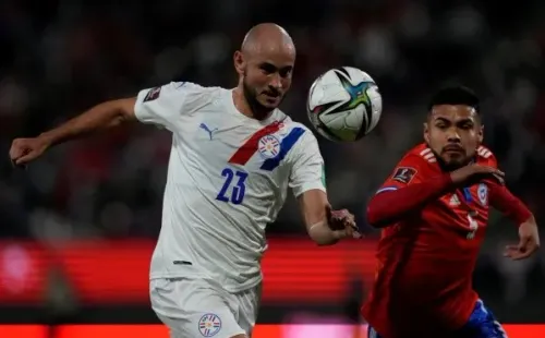 SANTIAGO, CHILE - OCTOBER 10: Carlos Gonzalez of Paraguay and Paulo Diaz of Chile fight for the ball during a match between Chile and Paraguay as part of South American Qualifiers for Qatar 2022 at Estadio San Carlos de Apoquindo on October 10, 2021 in Santiago, Chile. (Photo by Esteban Felix - Pool/Getty Images)-Not Released (NR)