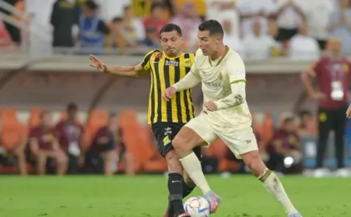 RIYADH, SAUDI ARABIA - MARCH 09: Cristiano Ronaldo of Al Nassr is tackled during the Saudi Pro League match between Al Ittihad and Al Nassr at King Abdullah Sports City, Jeddah on March 9, 2023 in Riyadh, Saudi Arabia. (Photo by Khalid Alhaj/MB Media/Getty Images)