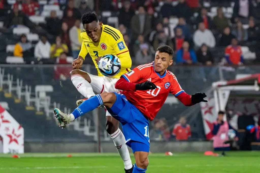 Alexis Sánchez lucha el balón ante Jeison Lucumí. (Guille Salazar/RedGol).