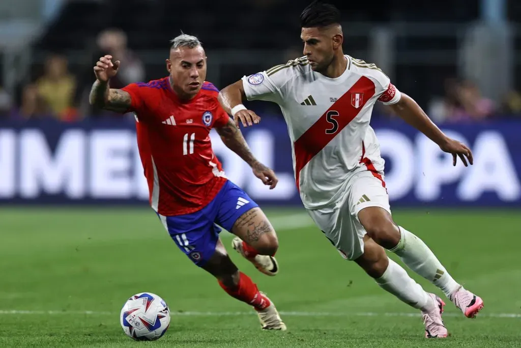 ARLINGTON, TEXAS – JUNE 21: Carlos Zambrano of Peru and Eduardo Vargas of Chile battle for the ball during the CONMEBOL Copa America 2024 Group A match between Peru and Chile at AT&T Stadium on June 21, 2024 in Arlington, Texas. (Photo by Omar Vega/Getty Images)