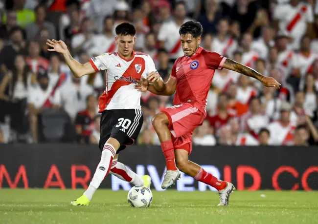 Franco Mastantuono de River disputando un balón contra Román Vega de Argentinos Juniors.