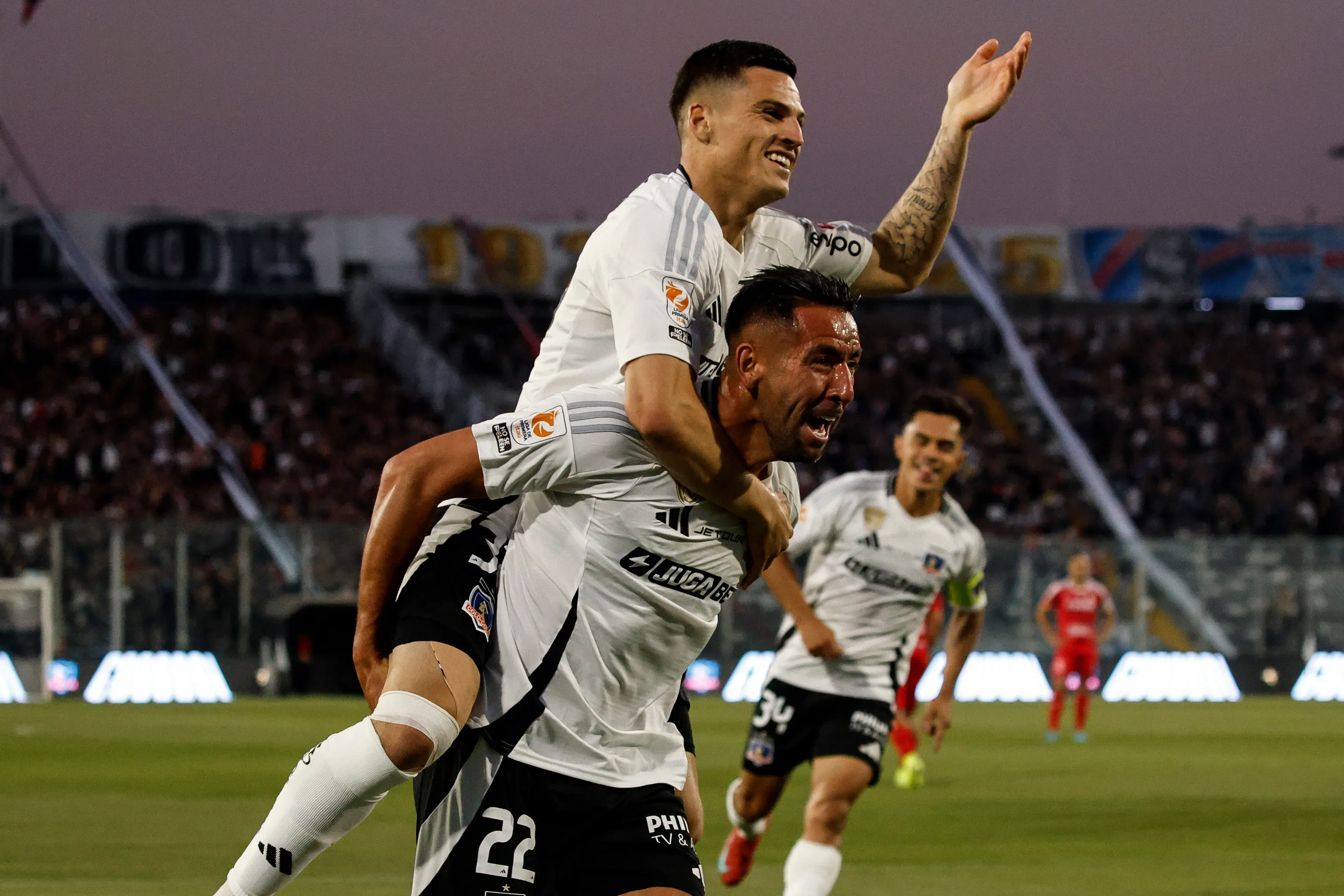 Mauricio Isla llevó en su espalda a Lucas Cepeda tras el golazo del “32” a La Calera. (Diego Martin/Photosport).
