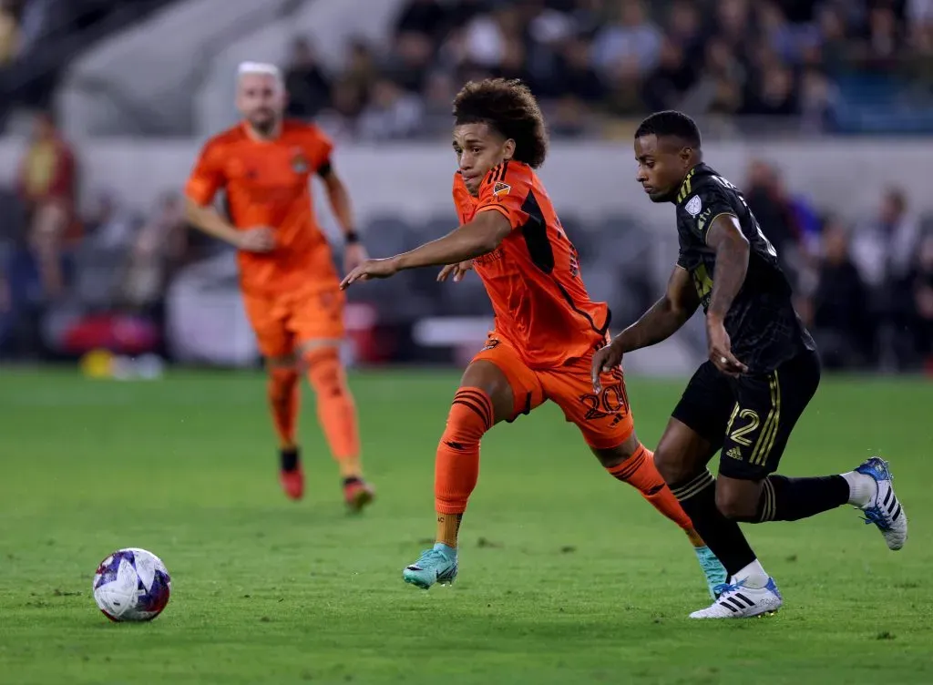 LOS ANGELES, CALIFORNIA – DECEMBER 02: Adalberto Carrasquilla #20 of Houston Dynamo chases after the ball in front of Diego Palacios #12 of Los Angeles FC during the first half at BMO Stadium on December 02, 2023 in Los Angeles, California. (Photo by Harry How/Getty Images)