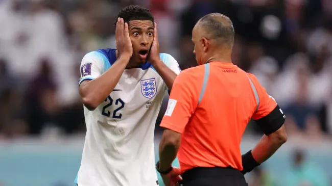 Wilton Pereira Sampaio, árbitro brasileiro, ao lado de Jude Bellingham em jogo da Copa do Mundo 2022 (Photo by Julian Finney/Getty Images)