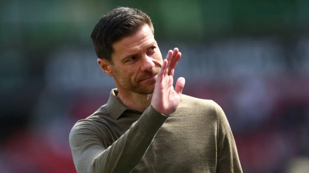 Xabi Alonso com a mão para o alto durante jogo do Bayer Leverkusen (Foto: Lars Baron/Getty Images)