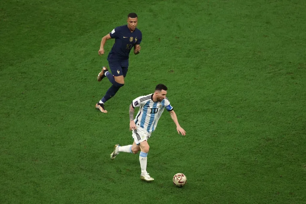 LUSAIL CITY, QATAR – DECEMBER 18: Lionel Messi of Argentina is chased by from Kylian Mbappe of France during the FIFA World Cup Qatar 2022 Final match between Argentina and France at Lusail Stadium on December 18, 2022 in Lusail City, Qatar. (Photo by Alex Pantling/Getty Images)