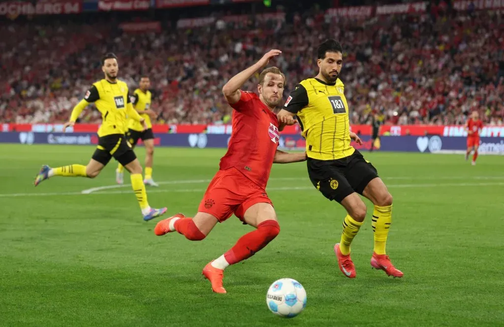 Harry Kane e Bensebaini em disputa de bola no jogo entre Bayern de Munique e Borussia Dortmund – Foto: Adam Pretty/Getty Images