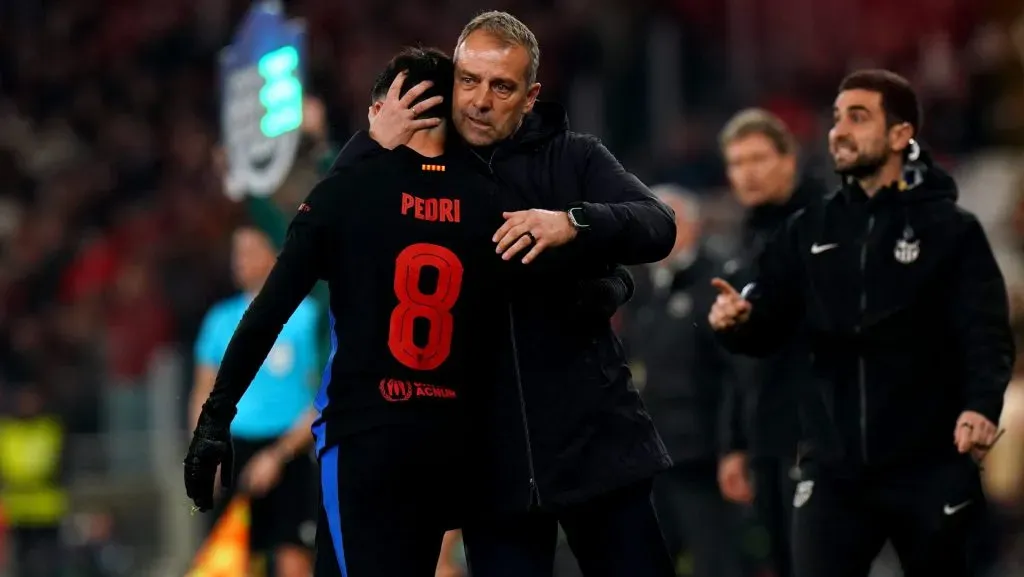 Pedri, do FC Barcelona, é abraçado por Hansi Flick, treinador do FC Barcelona, durante a partida de ida das oitavas de final da UEFA Champions League 2024/25 entre SL Benfica e FC Barcelona, no Estádio da Luz, em 5 de março de 2025, em Lisboa, Portugal. (Foto: Gualter Fatia/Getty Images)