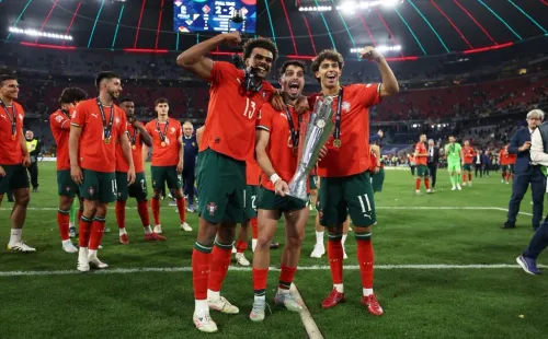 Renato Veiga, Pedro Neto e João Félix, jogadores do Chelsea, a celebrarem juntos a conquista da Nations League. Foto: Lars Baron/Getty Images.