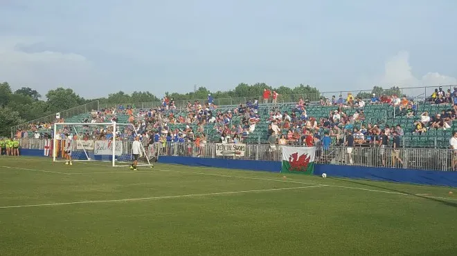 Players warming up pre-match in the summer heat.