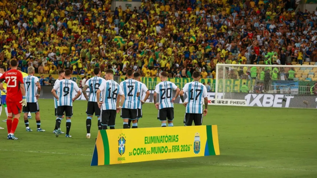 After the national anthems, Argentina players watch on as chaos unfolds in the stands in Rio de Janeiro.