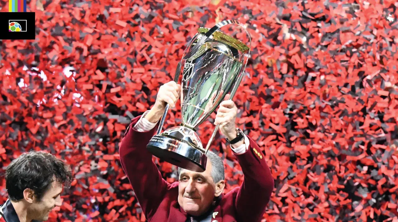 Atlanta United owner Arthur Blank holding the current MLS Cup trophy