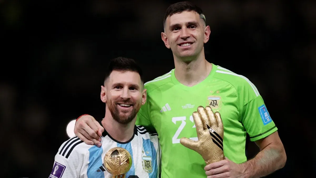Adidas Golden Ball winner Lionel Messi (L) and adidas Golden Glove winner Emiliano Martinez (R) of Argentina pose at the award ceremony following the FIFA World Cup Qatar 2022 Final match between Argentina and France at Lusail Stadium on December 18, 2022 in Lusail City, Qatar.