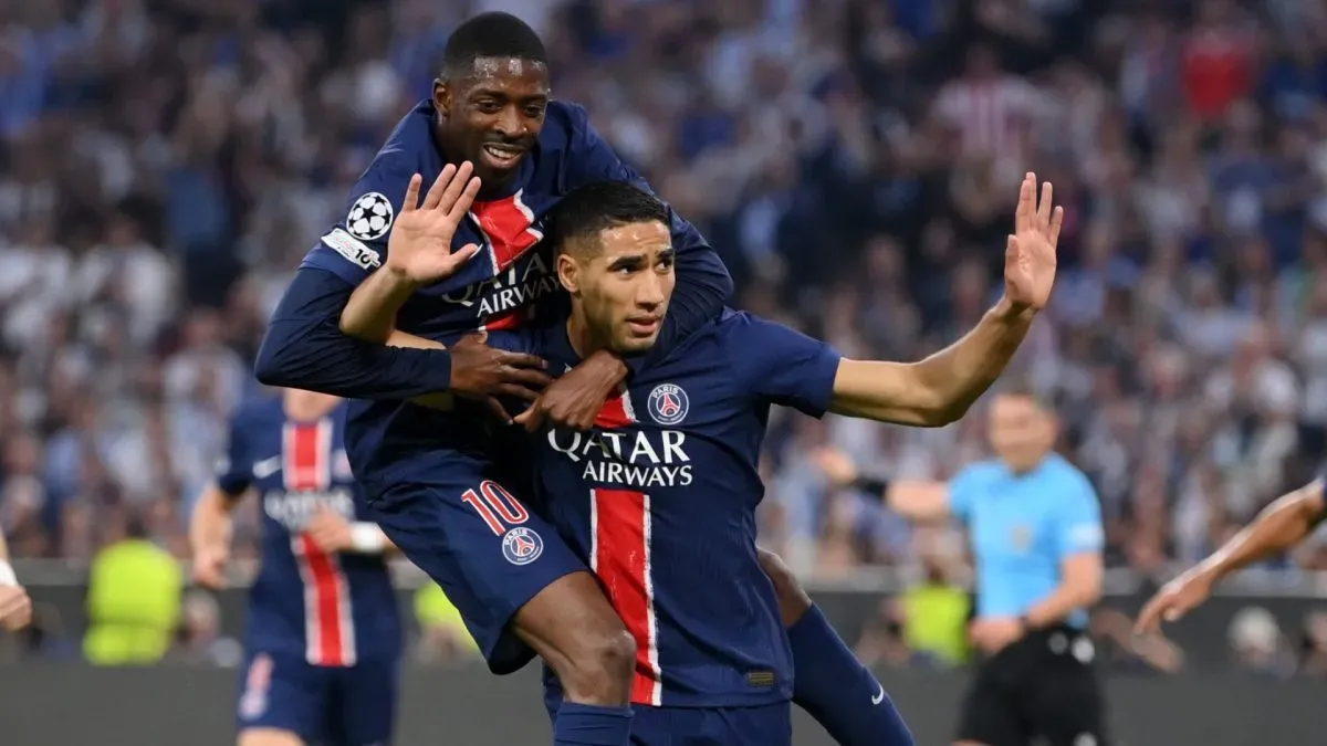 Achraf Hakimi of Paris Saint-Germain celebrates scoring his team's first goal with teammate Ousmane Dembele during the UEFA Champions League Final 2025 between Paris Saint-Germain and FC Internazionale Milano at Munich Football Arena on May 31, 2025 in Munich, Germany.