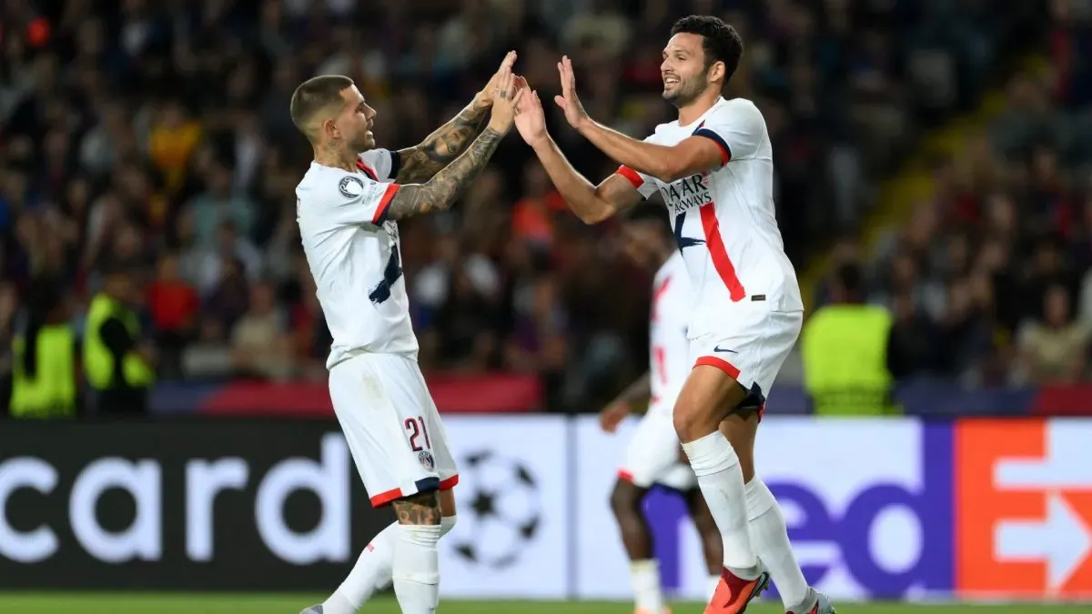 Goncalo Ramos of Paris Saint-Germain celebrates with teammate Lucas Hernandez after scoring his team's second goal against FC Barcelona.