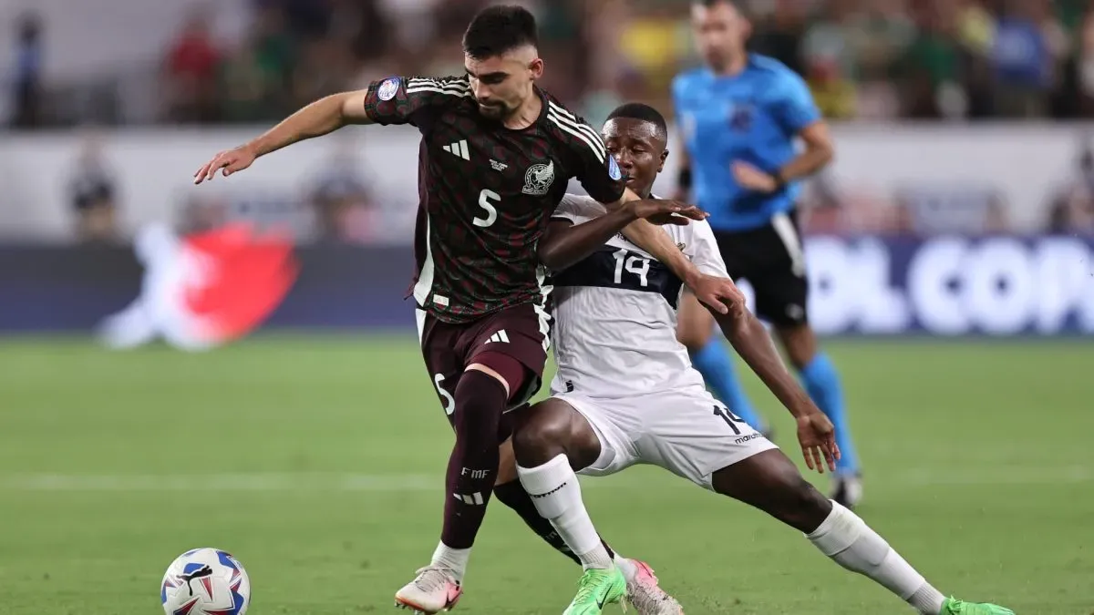 Johan Vasquez of Mexico battles for possession with Jordy Caicedo of Ecuador.