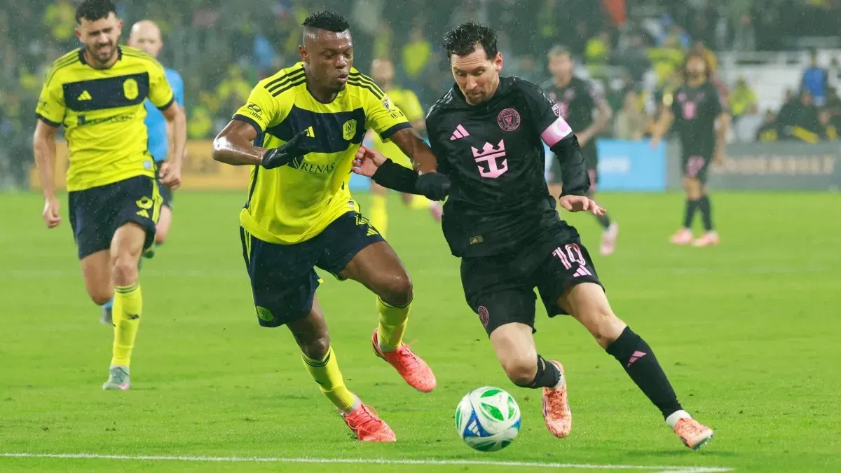 Lionel Messi #10 of Inter Miami CF battles for possession with Jeisson Palacios #4 of Nashville SC.