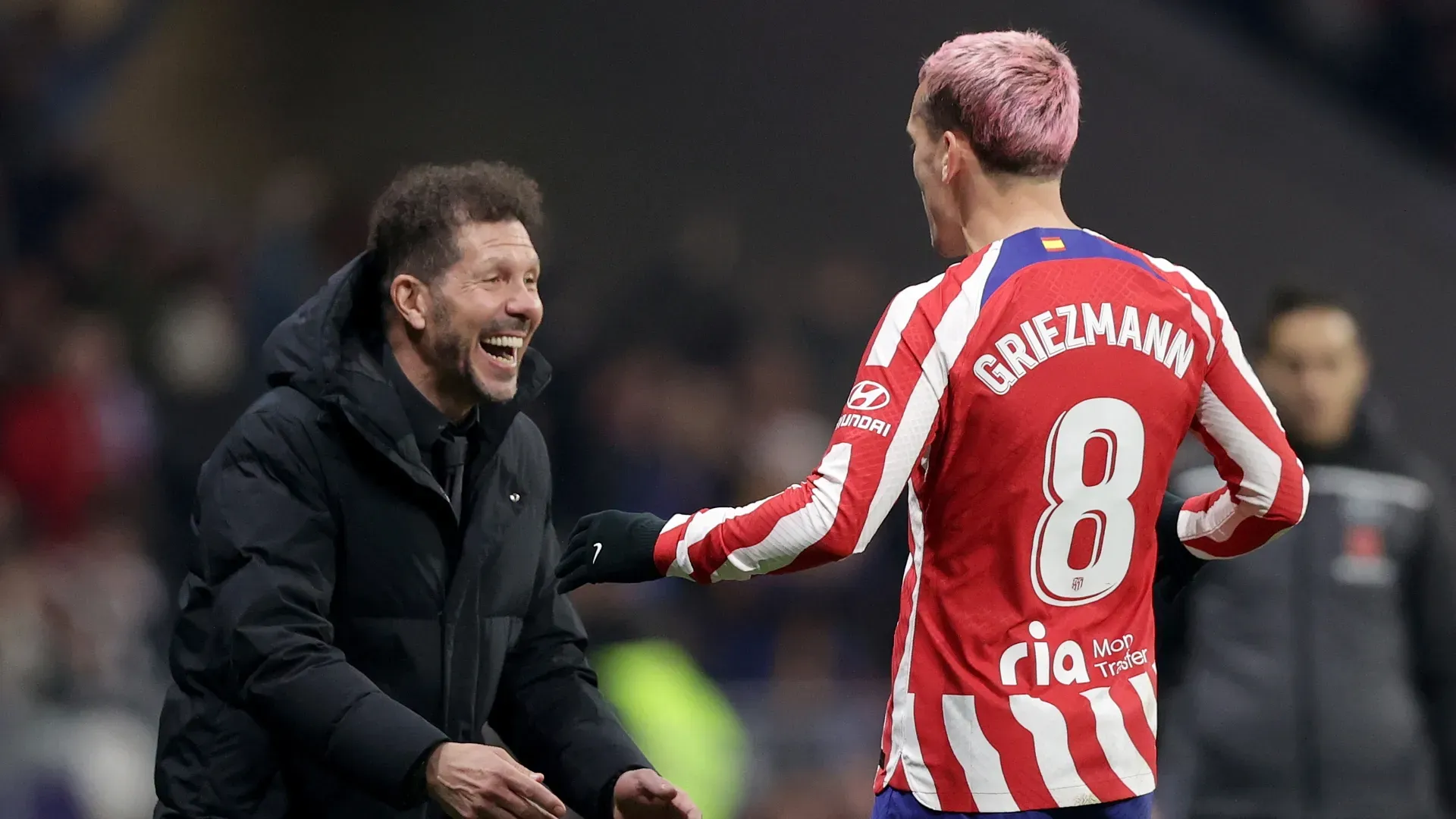 Antoine Griezmann of Atletico de Madrid celebrates after scoring their third side goal with Diego Simeone.