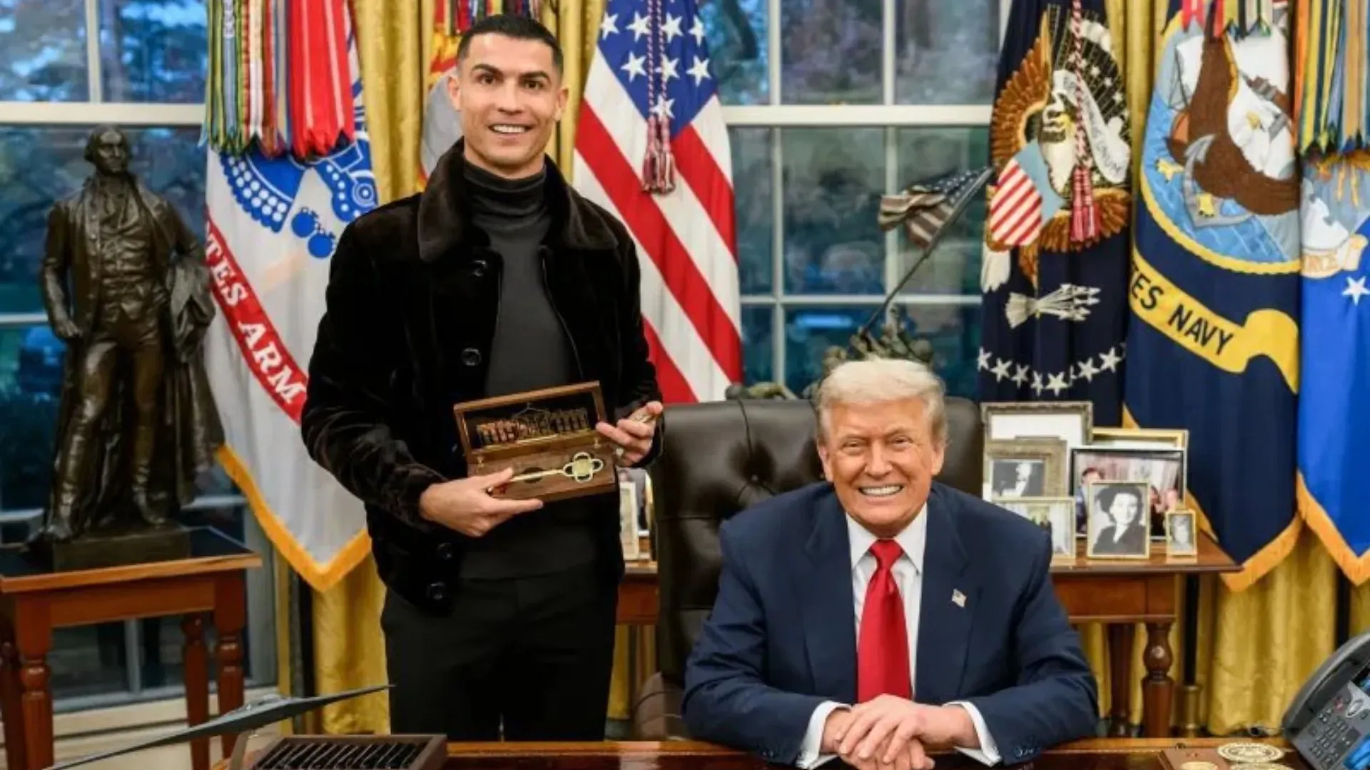 Cristiano Ronaldo at the Oval Office alongside U.S. President Donald Trump holding the White House key.