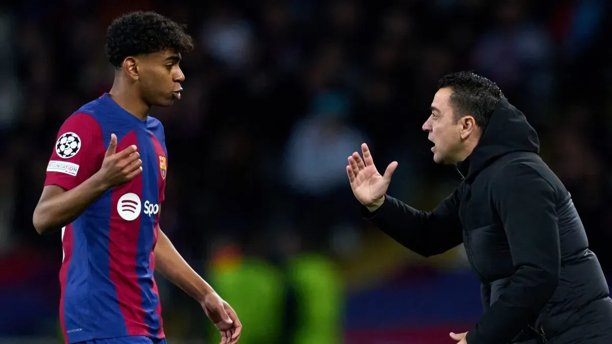 FC Barcelona Head Coach Xavi Hernandez interacts with Lamine Yamal of FC Barcelona during the UEFA Champions League 2023/24 round of 16 second leg match between FC Barcelona and SSC Napoli.