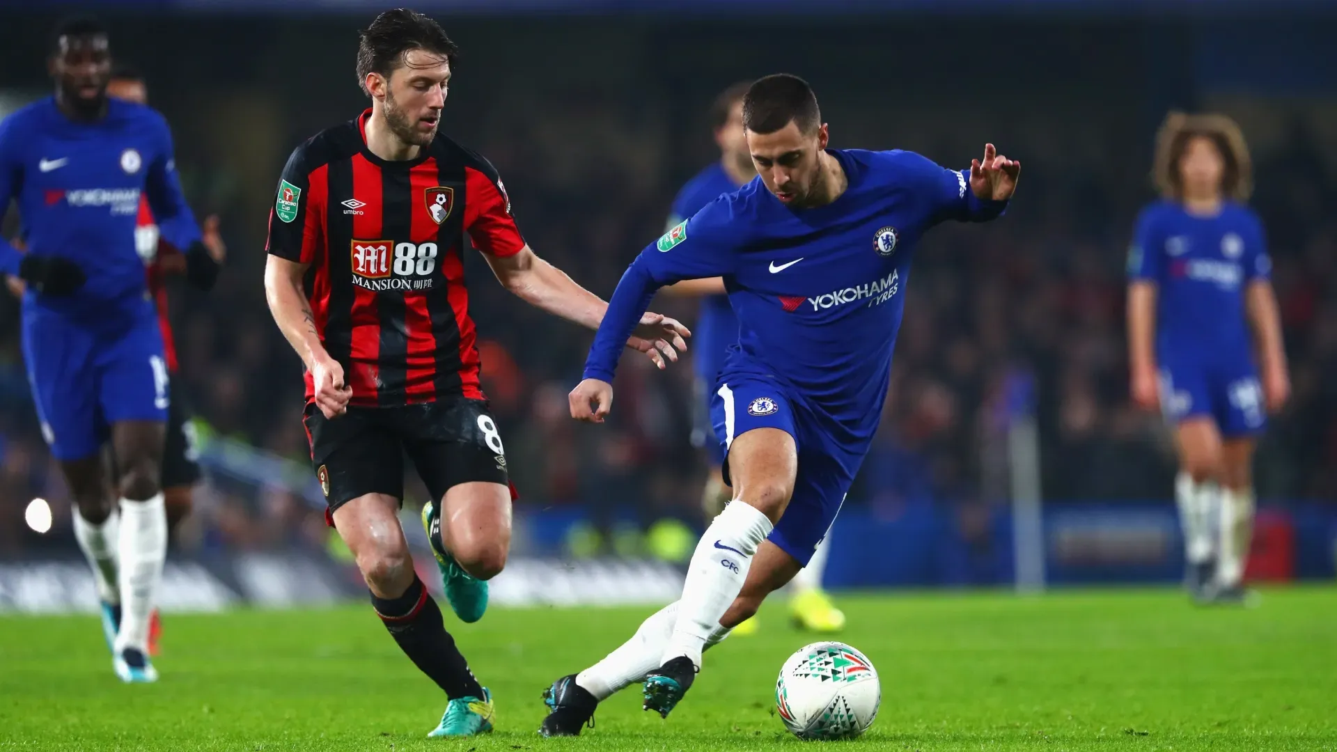Eden Hazard of Chelsea runs with the ball under pressure from Harry Arter of AFC Bournemouth.