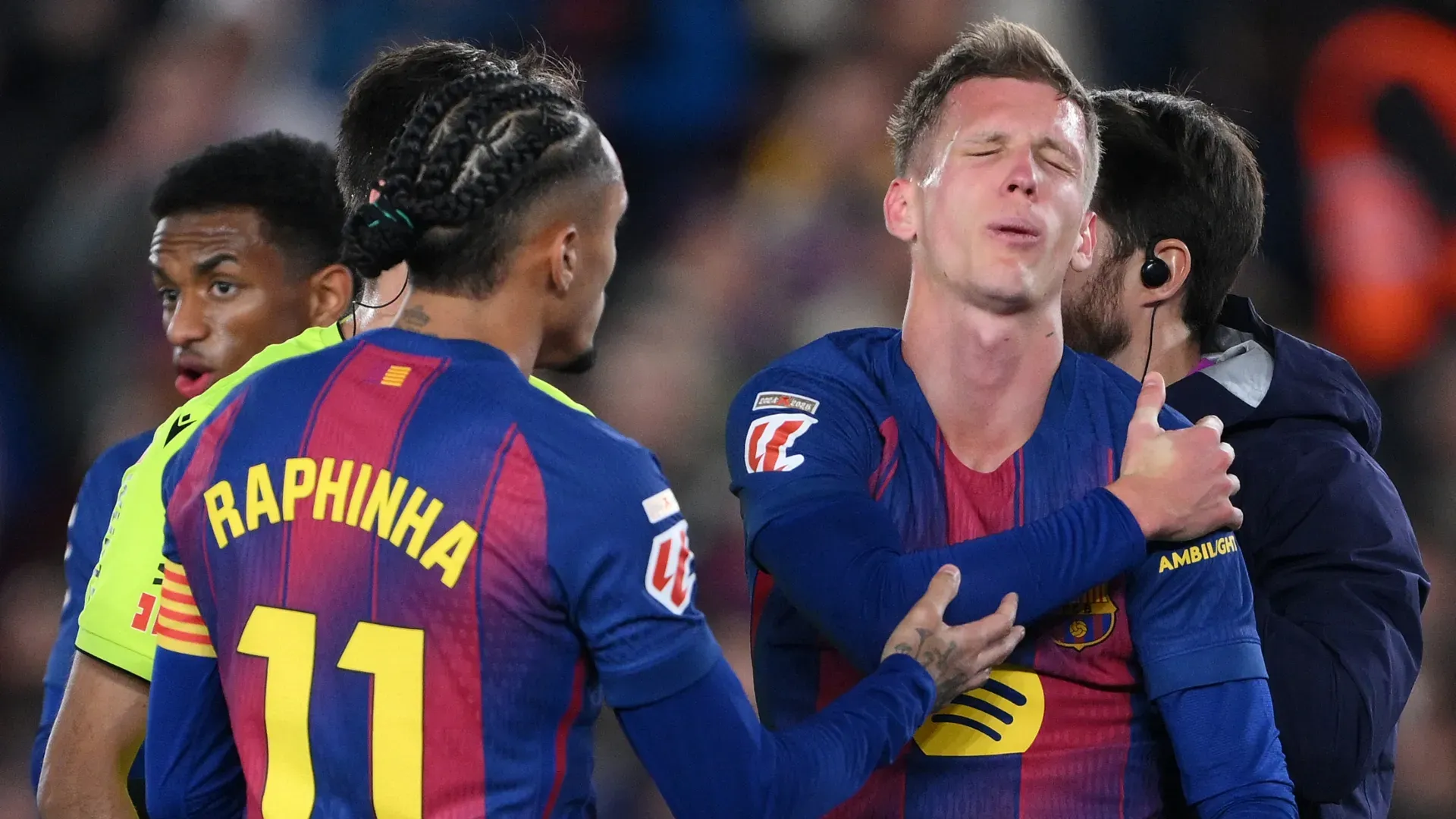 Dani Olmo of FC Barcelona reacts to an injury after scoring the second goal against Atletico Madrid.
