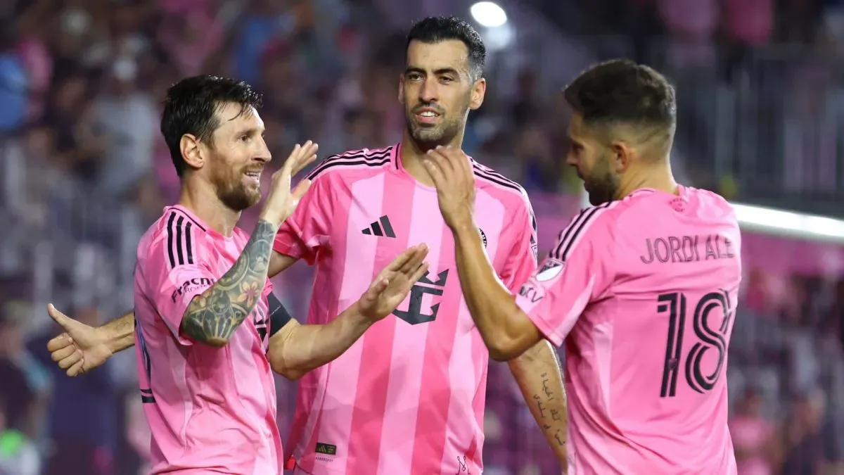 Lionel Messi #10 of Inter Miami CF celebrates after scoring the team's third goal with teammates Jordi Alba #18 and Sergio Busquets #5 of Inter Miami CF.