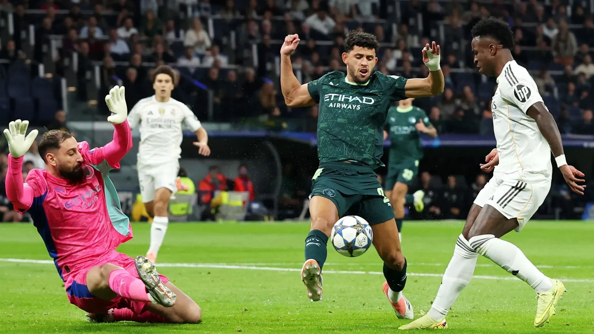 Real Madrid's Vinicius Jr and Manchester City's Matheus Nunes and Gianluigi Donnarumma.